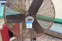 Front view of large industrial floor fan showing Global brand label on the center hub of the blades.
