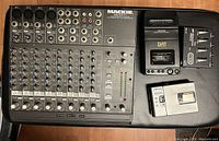 Overhead view of Mackie mixer front panel with faders and knobs, Denon DAT deck, Sony MiniDisc player, and Rolls headphone amp on black surface