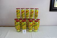 Fifteen upright Wilson Championship tennis ball cans arranged in two rows showing front and side views.