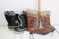 Two pairs of women's winter boots side by side with a ruler for size reference