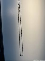 Full view of the men's silver chain necklace, showing its length and link style on white background.