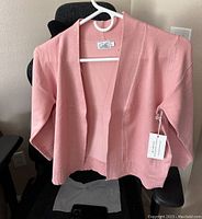 Front view of new dusty pink Cielo women's open-top shirt on hanger, showing original tag attached.