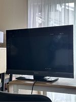 Front view of Sony 32-inch BRAVIA LCD TV turned on showing "No signal" message on the screen.