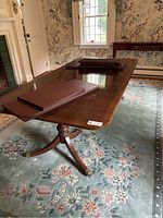 Full view of table with leaves stacked on top