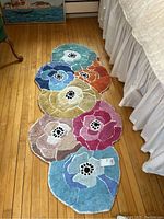 Full view of the Missoni Home floral pattern rug showing multiple interlinked colorful flowers and its unique shape.