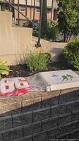 Washington Redskins jersey in plastic wrapping with number 86 and certification and box shown in outdoor setting.