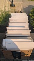 View of the box of comic books showing labeled dividers for categories such as Superman, Supergirl, Vigilante, Slash Maraud, Action Comics, and Miscellaneous.