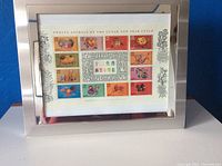 Framed display of the full sheet of twelve lunar new year animal postage stamps including the Year of the Rabbit