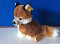 Front and side view of Steiff fox plush showing facial details and labels.