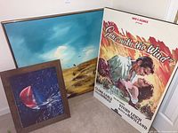 Photo showing the three framed prints leaning against the wall: sailing print, prairie print, and Gone with the Wind poster.