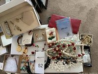 Overall lot with jewelry box containing earrings, several necklaces, watches, and a Monet butterfly pen box.