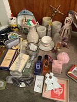 Overview of entire lot on carpet including ornaments, fragrances, figurines, and decor