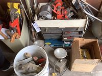 Overall view of lot including hand tools, vintage metal toolboxes, bucket with small hand tools, large pipe wrench in container