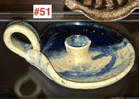 Front and side views of Canadian studio pottery chamber candlestick, showing the curved handle, glazing, and candle holder.