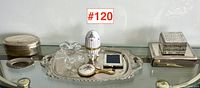 Overview of silver serving tray with assorted ladies' dresser items including glass bowl, porcelain egg box, compact mirror, hand mirror, and jewellery boxes.
