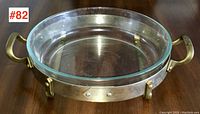 Full top view of the Nilsjohan round serving dish showing the glass insert and brass handles