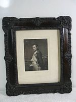 Full front view of the antique wooden frame with portrait print inside