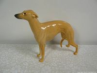 Side view of Beswick Whippet figurine showing slender body and curled tail