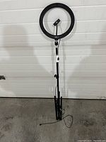 Full view of the Mobifoto ring light mounted on its tripod stand, showing height and overall appearance.