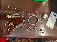 Top‐down view of all jewelry pieces on wooden surface