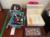 Overview of the lot including nail polish bottles, basket, candle, fragrance sets, and trimmer.