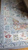 Close-up of the rug's patterned design showing colors and weave.