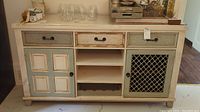 Front view of entire sideboard showing drawers, cabinets, and shelving with wine insert.