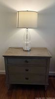 Front view of side table with lamp atop