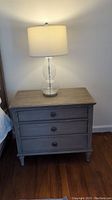 Front view of side table with lamp on top