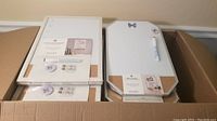 Opened box showing multiple dry erase weekly and combo boards with frames.