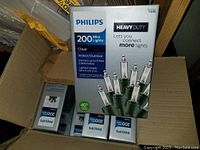 Photo showing front of one box of Philips Heavy Duty 200 Mini Clear Lights with product details visible.