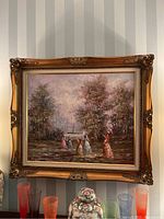 Full view of framed oil painting showing scene of Victorian figures by water and gold-tone ornate frame