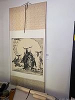 Full view of one large hanging scroll mounted on wall, silk brocade top and bottom, painting of owls on paper