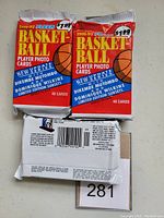 Three unopened jumbo packs of 1991-92 Fleer Basketball cards placed on a white surface. Two packs show the front with colorful design and price stickers; one pack shows the back with barcode and legal text.