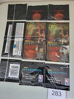 Three unopened 1994 Topps Stadium Club basketball rack packs shown on a table, displaying front and back packaging with basketball player imagery and text about included cards.