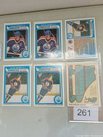 Photo shows six Wayne Gretzky hockey cards from 1992 O-Pee-Chee Anniversary Series. Three fronts and three backs of cards visible, all featuring Gretzky in Edmonton Oilers uniform with player stats on the back.