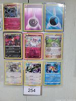 Photo of 9 holographic Pokémon trading cards arranged in a 3x3 grid. Cards include Metagross, Psychic Energy, Water Energy, Yveltal, Sylveon, Buzzwole, Bisharp, Tornadus, and Starmie.