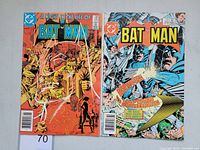 Front covers of Batman #383 and Batman #388 vintage DC comic books showing cover art and condition.