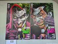 Front covers of Batman Three Jokers Book One and Two comic books showing Joker artwork in vivid colors.