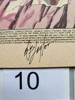 Close-up photo showing Bob Layton's autograph on the first page near publication details.