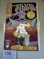 Front cover of Silver Surfer #50 comic with chrome embossed effect and Thanos background artwork.