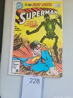 Front cover of Superman #1 comic book with a green robotic figure and Superman in foreground. Features text 'It's your first issue' and credits Byrne & Austin.