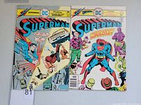 Front covers of Superman #290 and #299 vintage DC comic books showing colorful artwork and titles.