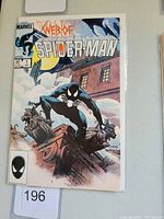 Front cover of Web of Spider-Man #1 comic showing Spider-Man in black suit on rooftop at night under full moon.