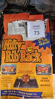 Front view of the Nifty Rib Rack packaging showing branding, tagline, and cooking instructions