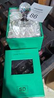 Crystal perfume bottle in green box with satin lining, box labeled with brand SD and 'Crystal Perfume Bottle'