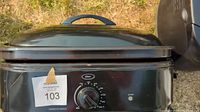 Black electric roaster oven front view with temperature dial