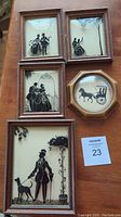 Photo showing all five framed silhouette pictures, four rectangular and one octagonal