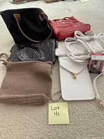 Photo showing six assorted purses: large black tote, red handbag, black snakeskin textured purse, brown knit bag, small white purse with gold clasp, and a white zippered purse with strap.