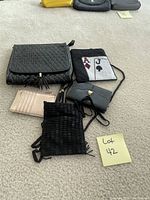 Five assorted purses including black quilted, pink cardholder, black woven, ace and jack spade playing card design, and small gray purse.